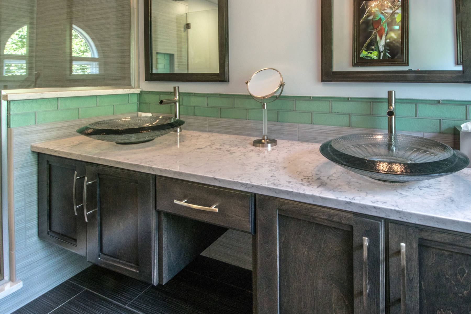 Sophisticated his and hers vanities with green tile