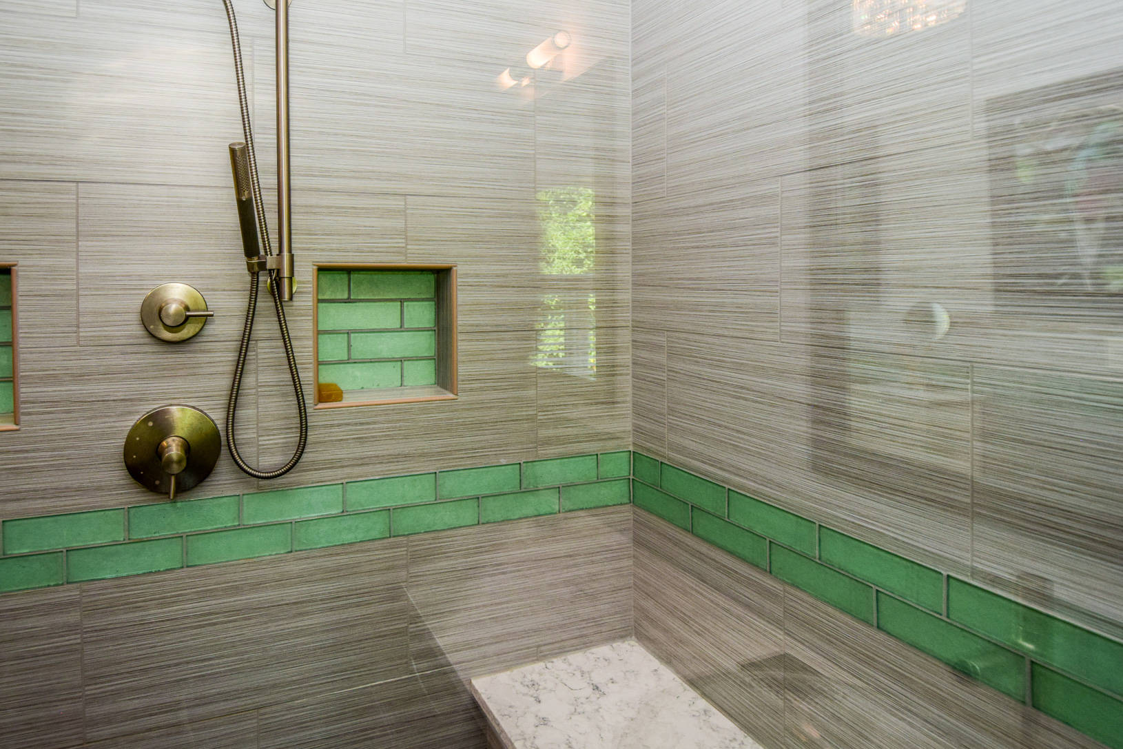 shower with green accent tile