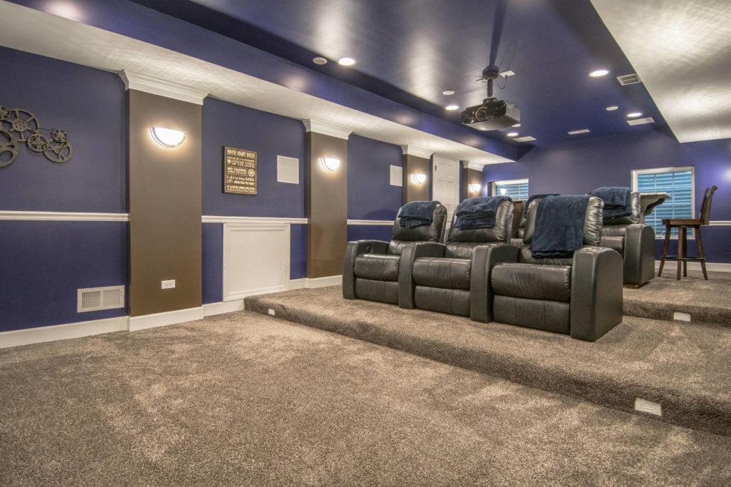 finished purple theater room with stadium seating