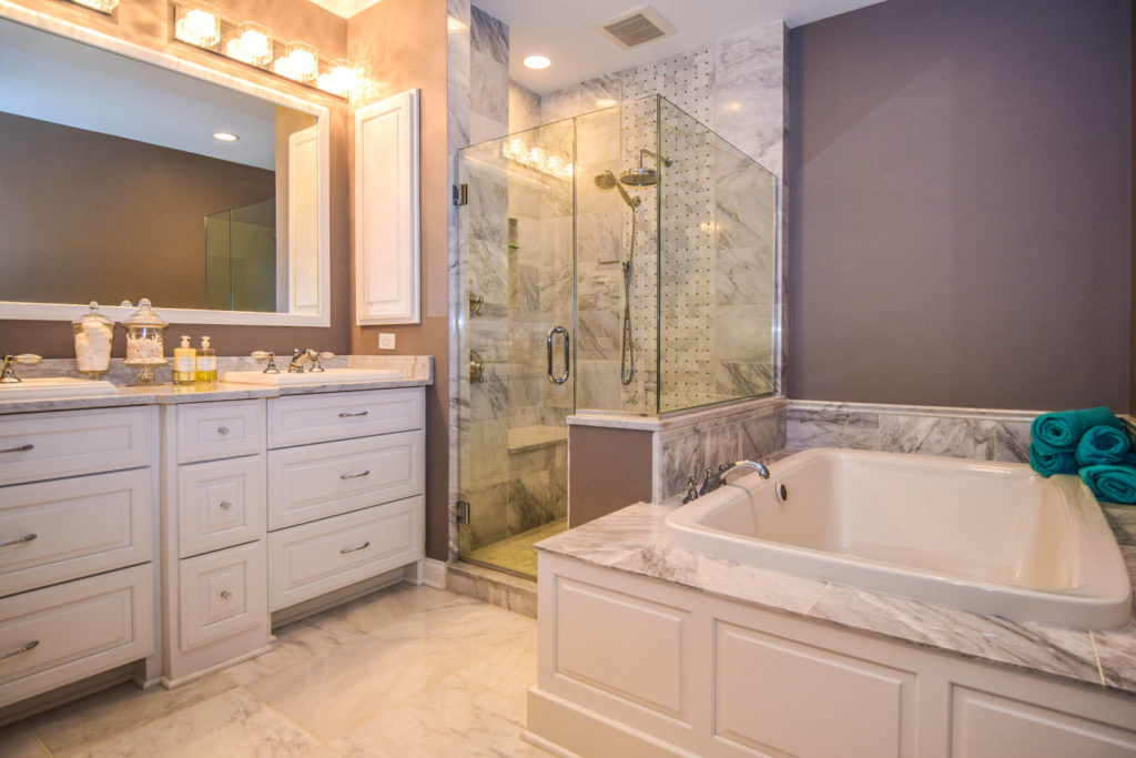 white and gray bathroom with tub and stand up shower