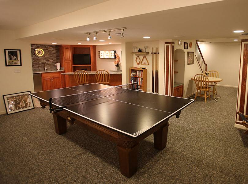Finished basement with wet bar and game table