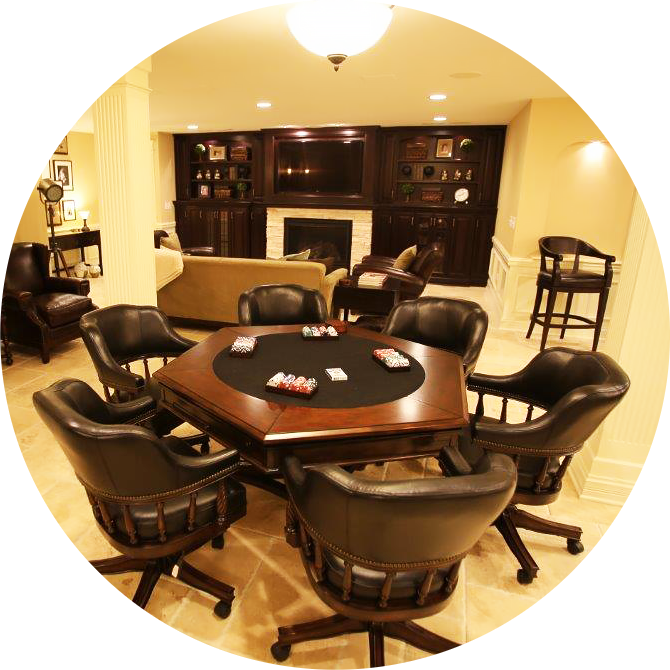 Basement remodeling featuring a poker table surrounded by chairs, a fireplace, and a sofa in the background for a warm, inviting atmosphere