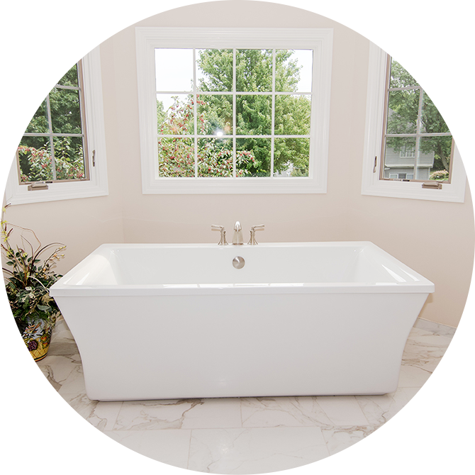 a white bath tub sitting under a window