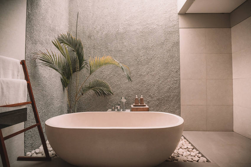 A white ceramic bathtub in a modern and stylish bathroom.