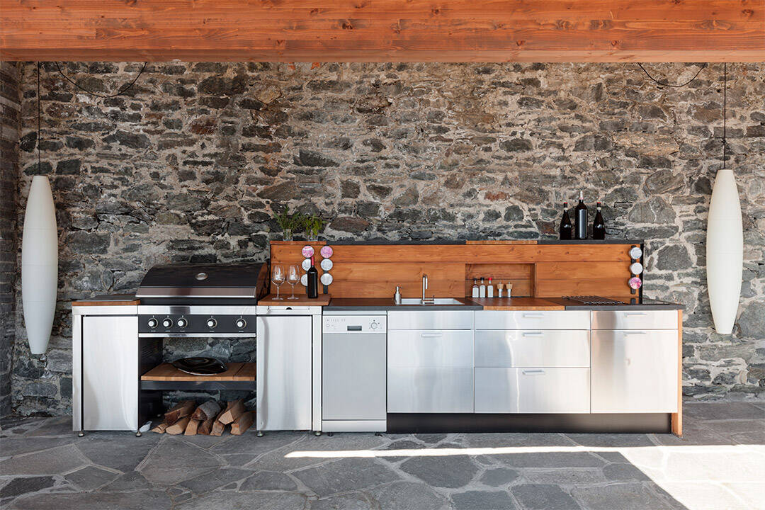 a kitchen with a stone wall and a stove